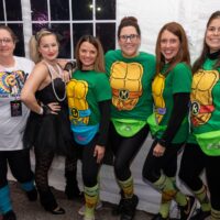 six ladies, four in ninja turtles costumes, one in Madonna costume, one in MTV t-shirt during Wyandotte's 80s vs 90s Halloween Pub Crawl