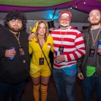 four friends with beer cans; one in Where's Waldo costume, one in Pikachu costume during Wyandotte's 80s vs 90s Halloween Pub Crawl