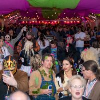 view of crowd under big tent during Wyandotte's 80s vs 90s Halloween Pub Crawl