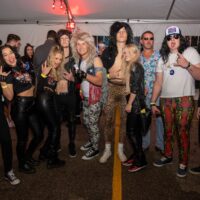 group of friends in 80s rocker costumes during Wyandotte's 80s vs 90s Halloween Pub Crawl