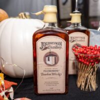 Journeyman Distillery Whiskey bottle with pumpkin fall display on table during Wyandotte's Detroit River Cocktail Showdown