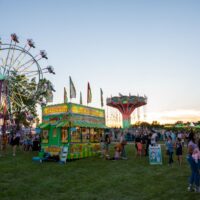 carnival rides and lemonade food truck stand with crowd of people at Riverview Summerfest