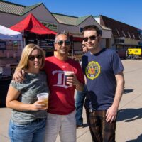 three people with beer cups posing for camera during Rockin' the Shores Festival