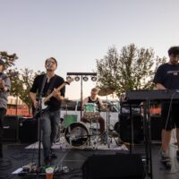 four member band on small stage during Rockin' the Shores Festival