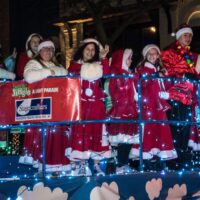 float with people in cute Christmas outfits from Stagecrafters in parade during Royal Oak Jingle