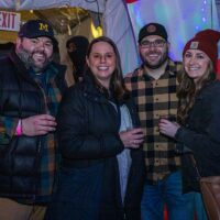 two couples smiling at camera while holding glasses at Wyandotte's Winter Beer Cocktail Fest