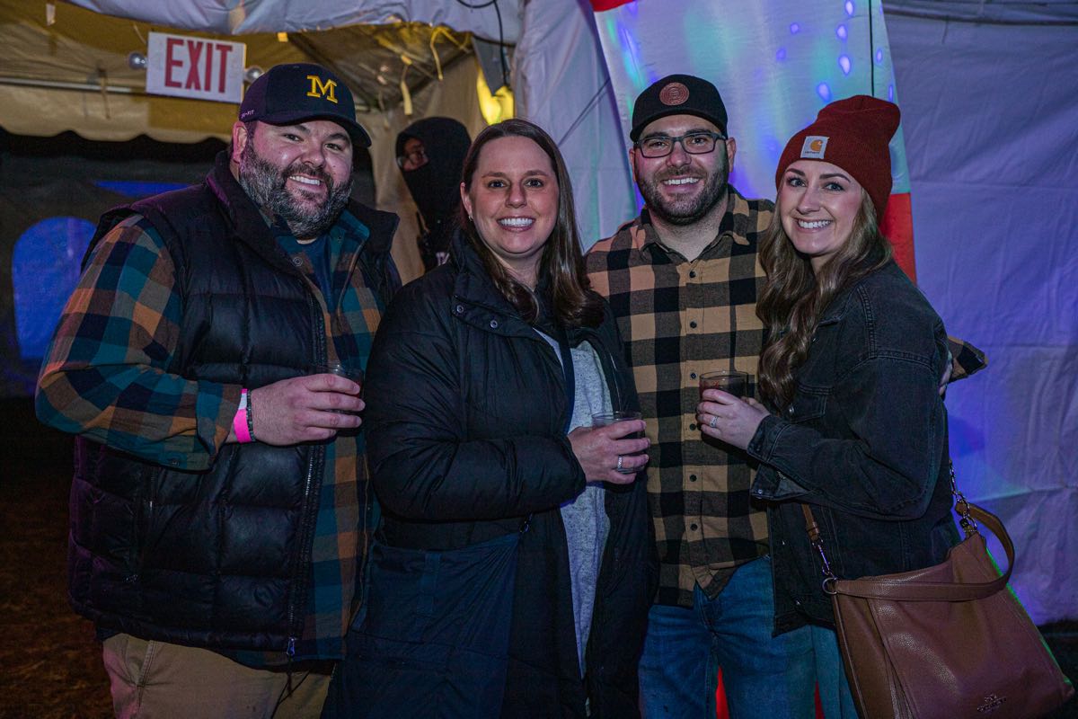 two couples smiling at camera while holding glasses at Wyandotte's Winter Beer Cocktail Fest