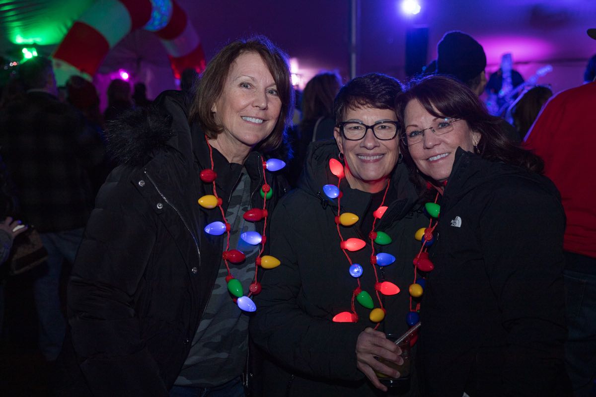 three ladies wearing Christmas light necklaces at Wyandotte's Winter Beer Cocktail Fest