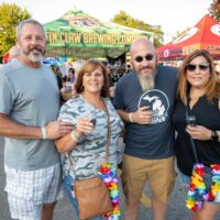 two couples in front of beer tents during Wyandotte's Beer Fest
