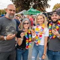 two couples wearing Hawaiian lei necklaces during Wyandotte's Beer Fest