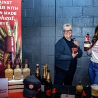 Maker's Mark bourbon vendor stand with two woman displaying product