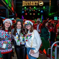 Four ladies inside District 142 wearing Holiday gear smiling and posing.